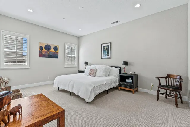 a spacious bedroom with a bed and a desk