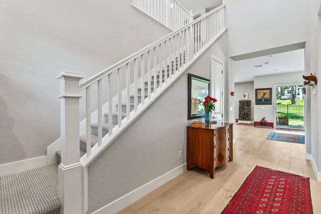 a view of entryway and hall with wooden floor
