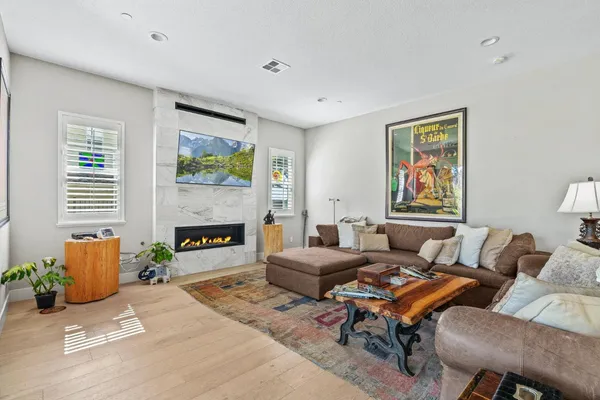a living room with furniture a fireplace and a flat screen tv