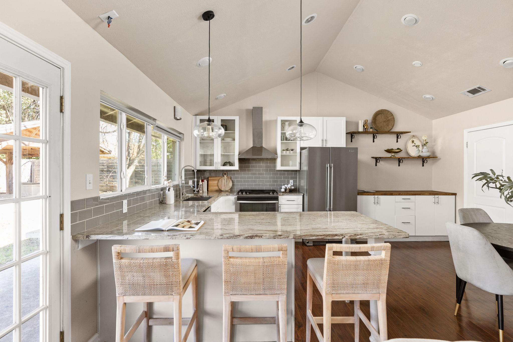 6502 Highpoint Cove Austin, TX 78723 - Photo 12 of 40 Kitchen with white cabinetry, a peninsula, light stone counters, and pendant lighting