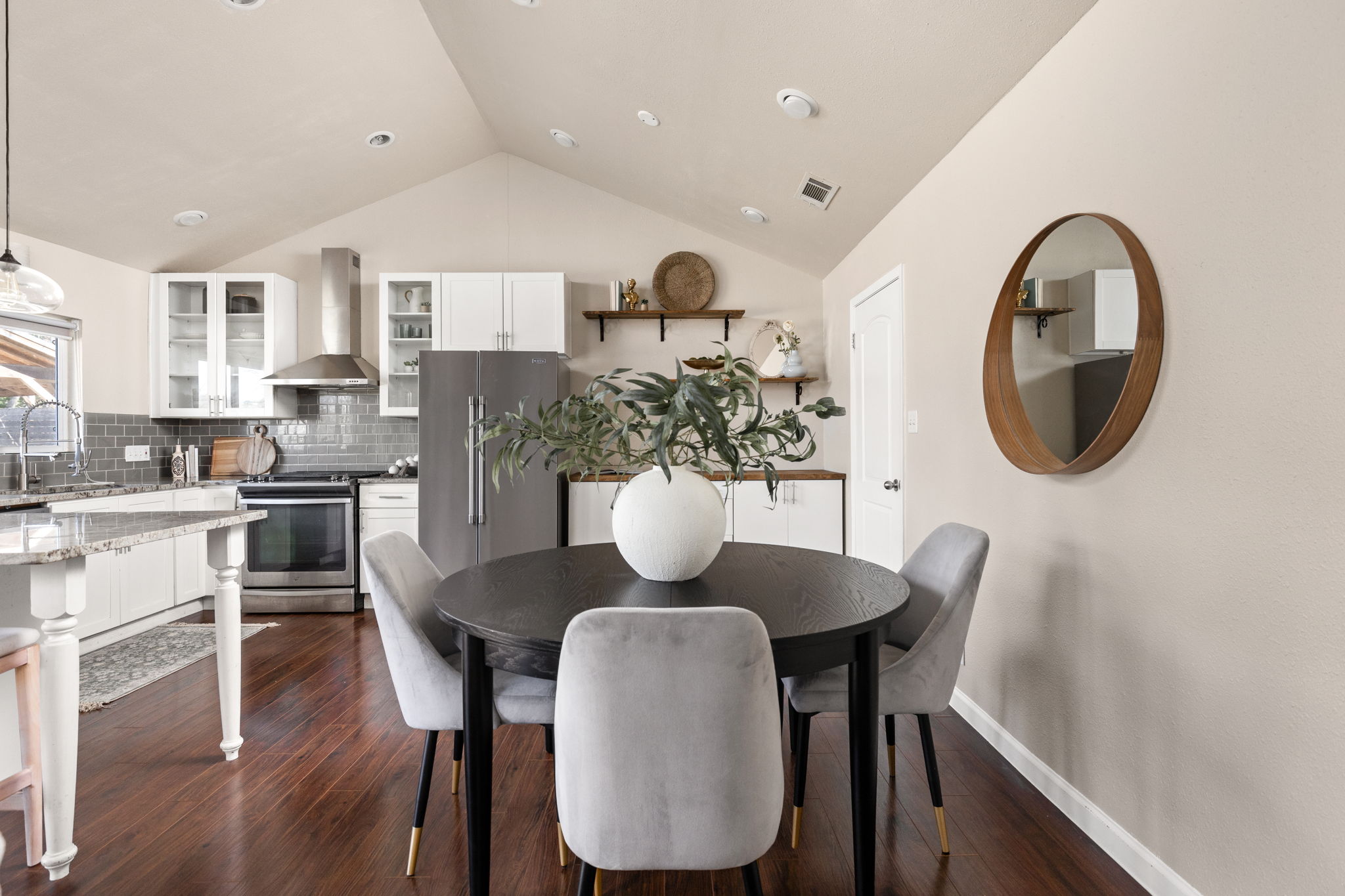 6502 Highpoint Cove Austin, TX 78723 - Photo 13 of 40 Dining space with vaulted ceiling and dark wood-style flooring