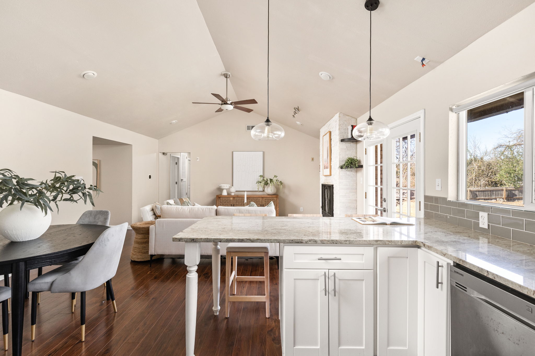 6502 Highpoint Cove Austin, TX 78723 - Photo 19 of 40 Kitchen featuring dishwasher, pendant lighting, a peninsula, dark wood-style floors, and white cabinetry