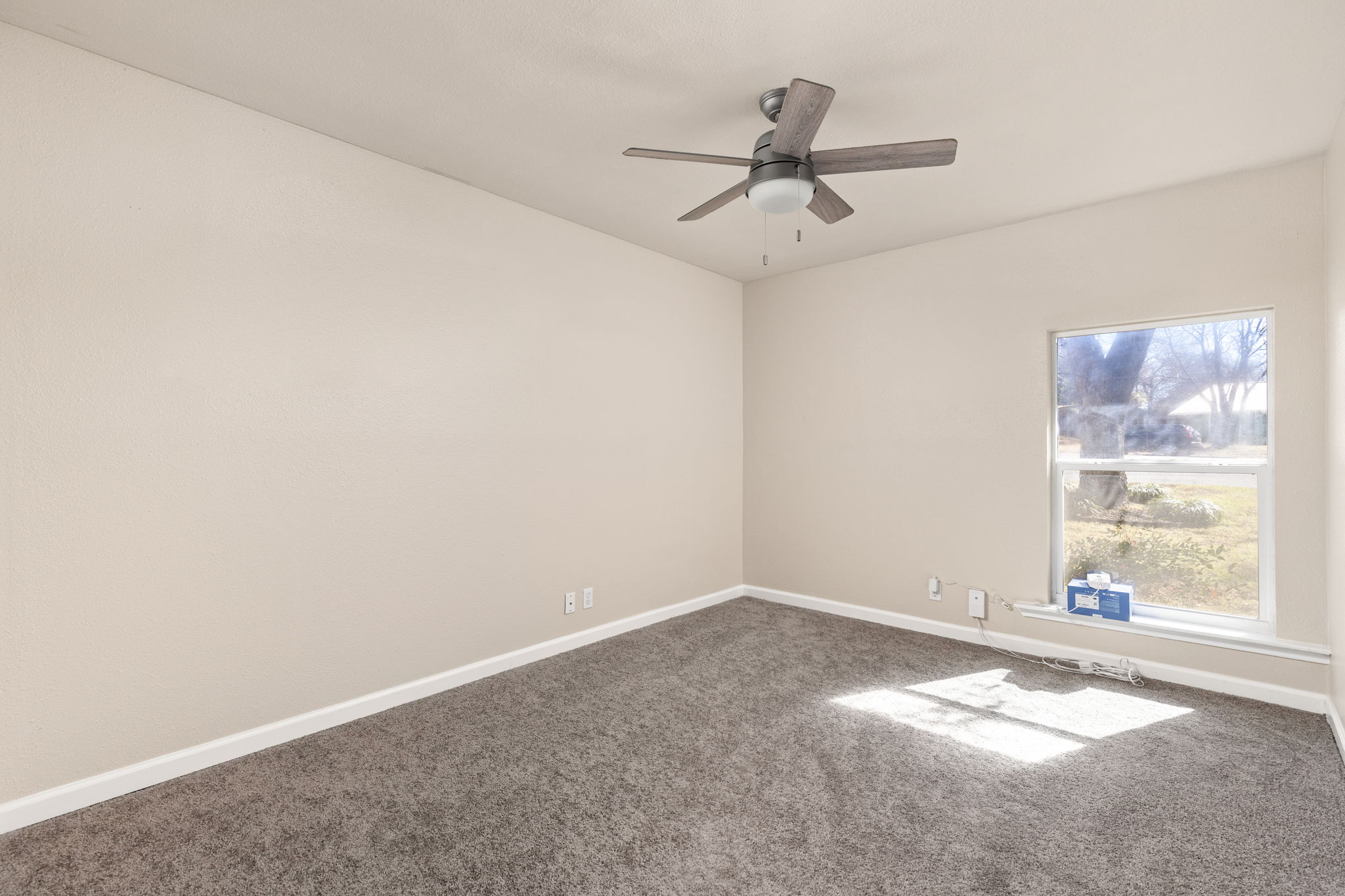 6502 Highpoint Cove Austin, TX 78723 - Photo 26 of 40 Carpeted spare room featuring baseboards and a ceiling fan