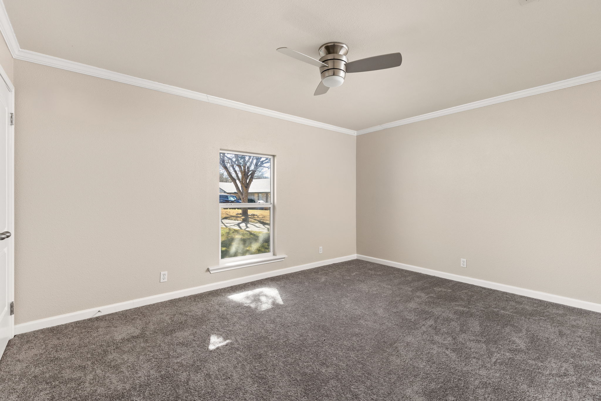 6502 Highpoint Cove Austin, TX 78723 - Photo 29 of 40 Empty room with ornamental molding, dark colored carpet, and a ceiling fan