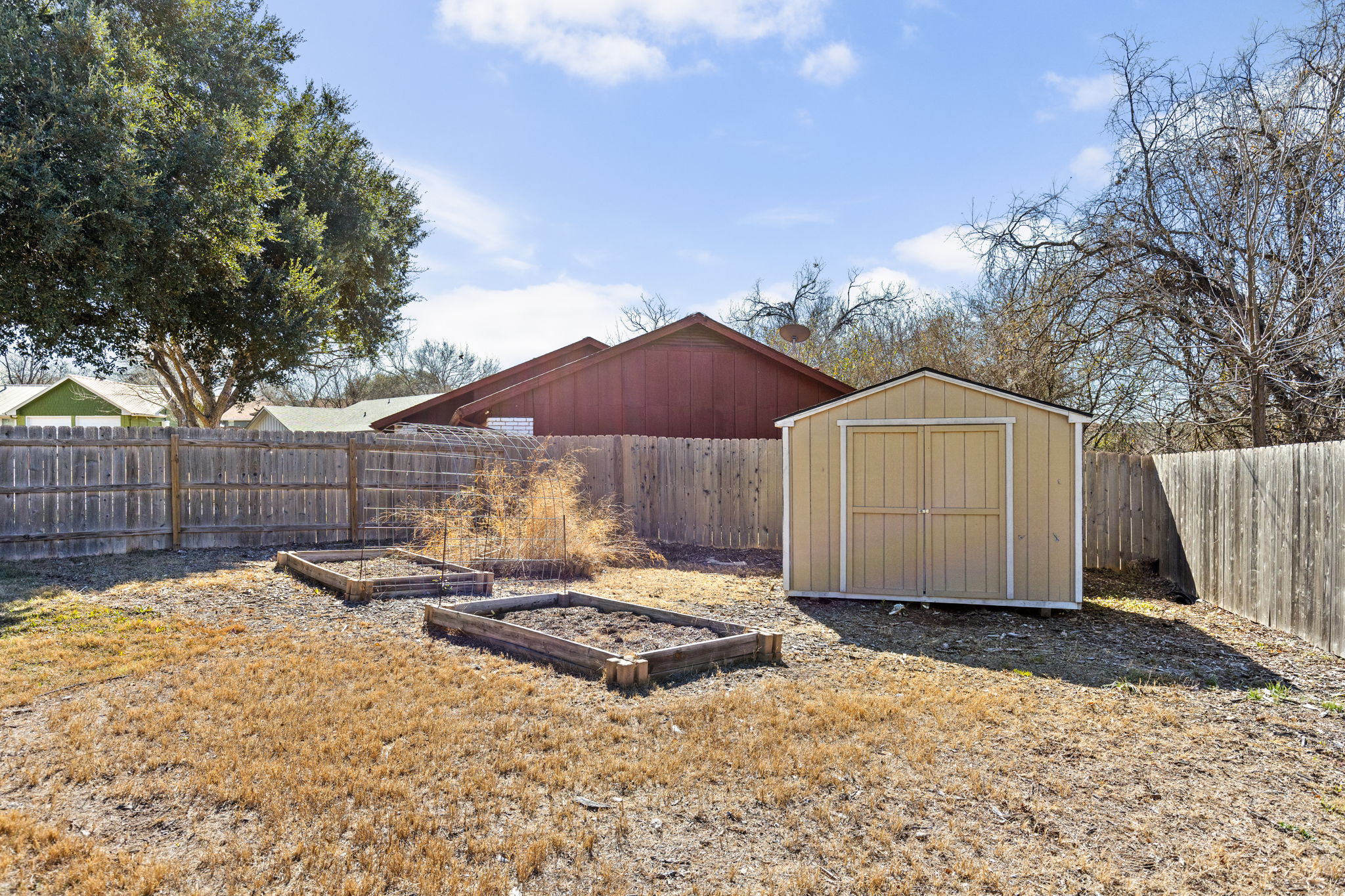 6502 Highpoint Cove Austin, TX 78723 - Photo 37 of 40 View of shed featuring a vegetable garden and a fenced backyard