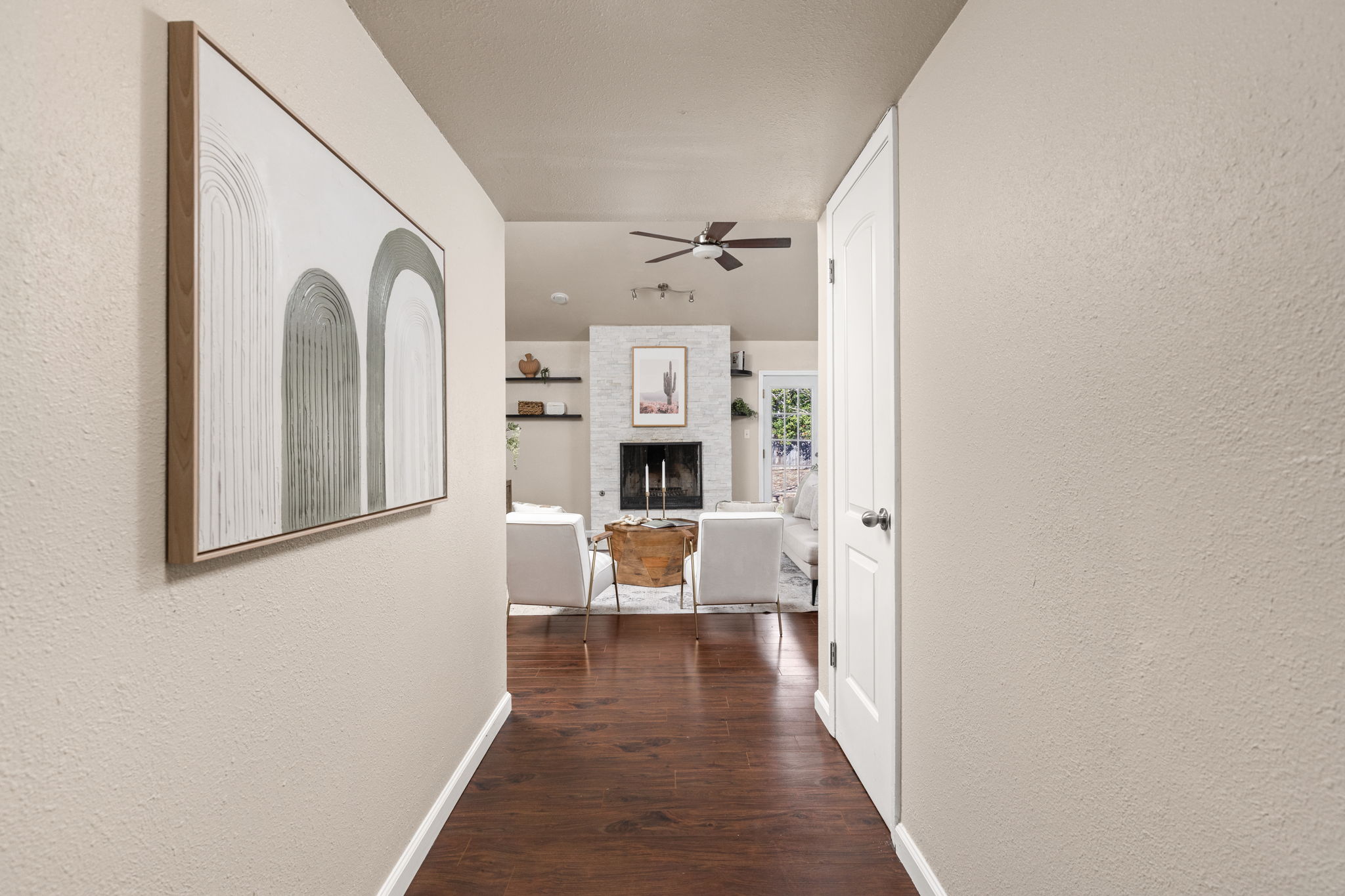 6502 Highpoint Cove Austin, TX 78723 - Photo 5 of 40 Corridor featuring a textured wall and dark wood finished floors