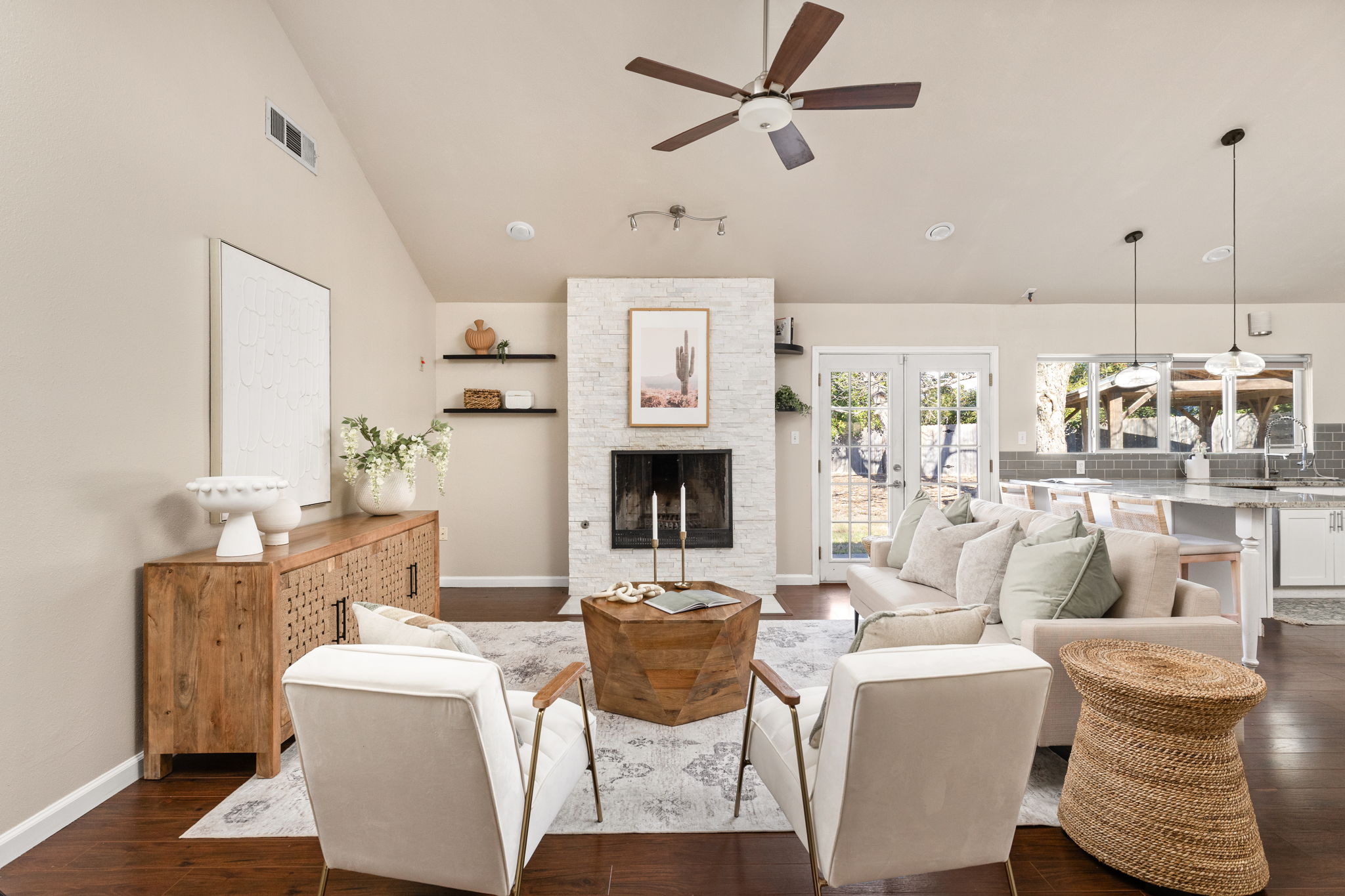 6502 Highpoint Cove Austin, TX 78723 - Photo 6 of 40 Living area featuring lofted ceiling, ceiling fan, dark wood-style flooring, a fireplace, and french doors