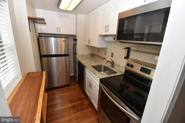 a kitchen with a refrigerator stove and microwave