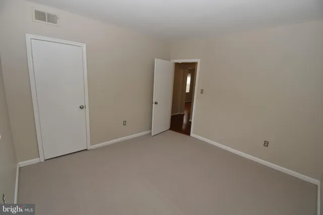 an empty room with closet area