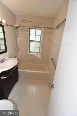 a bathroom with a bathtub a sink a toilet a vanity and a shower