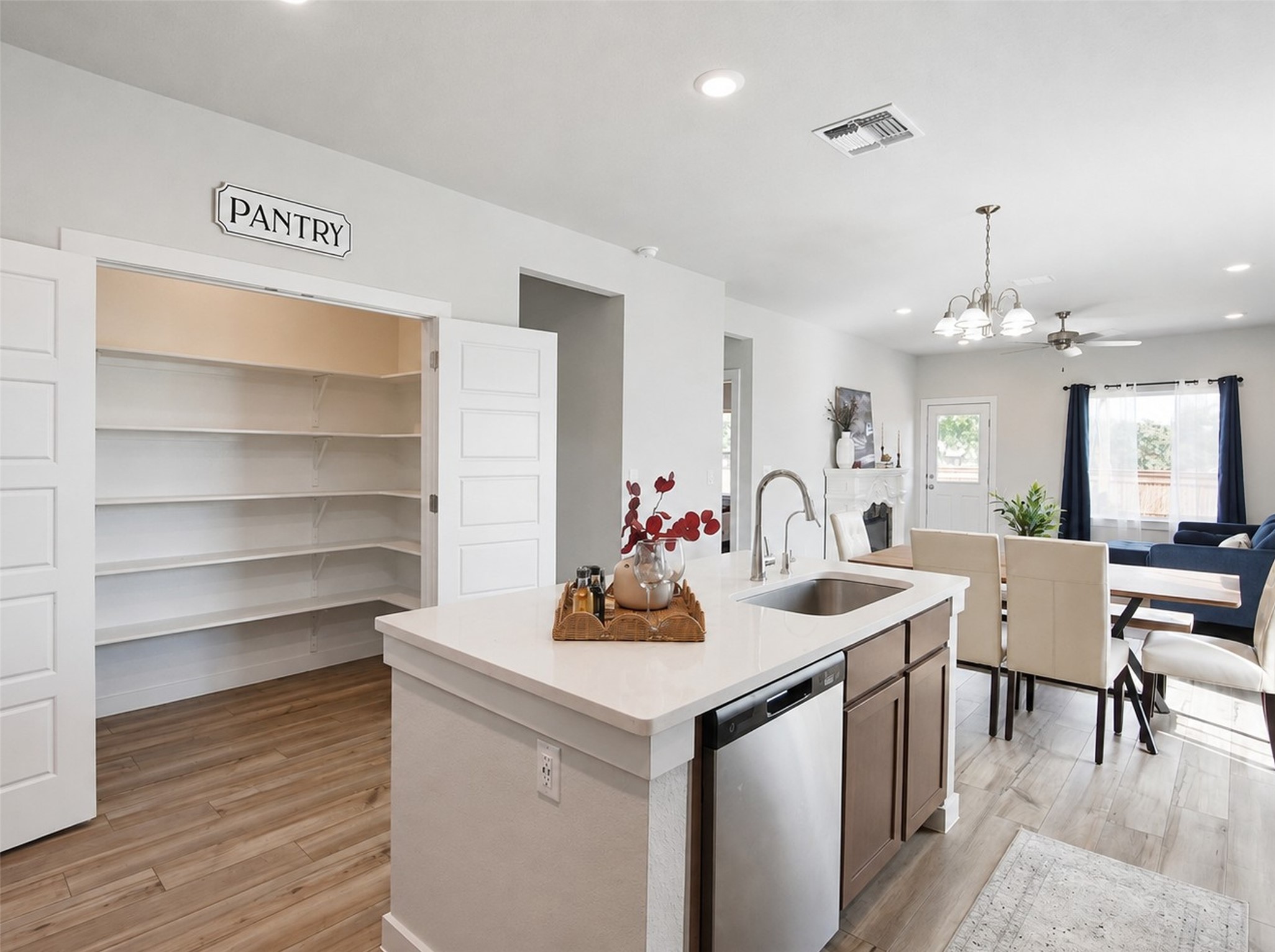 1924 Split Rock Road New Braunfels, TX 78130 - Photo 5 of 20 A spacious walk-in pantry stands adjacent to a modern kitchen island with integrated sink.