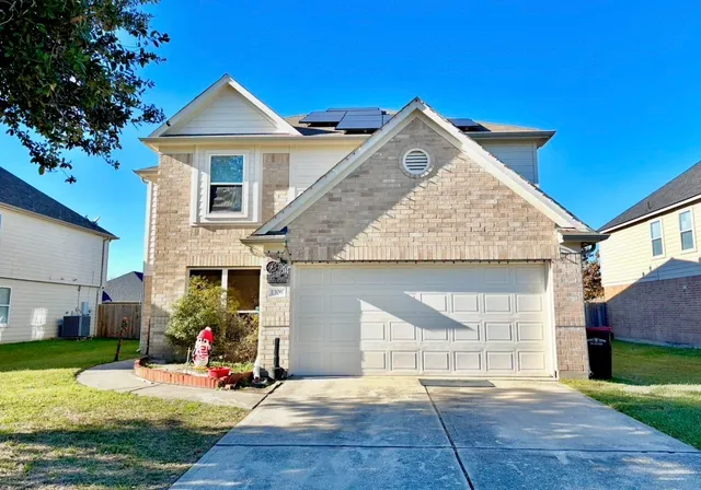 a view of a house with a yard and sitting area