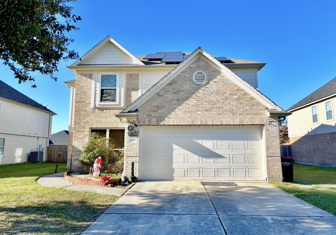 a view of a house with a yard and sitting area