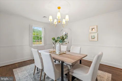 a view of a dining room with furniture and chandelier