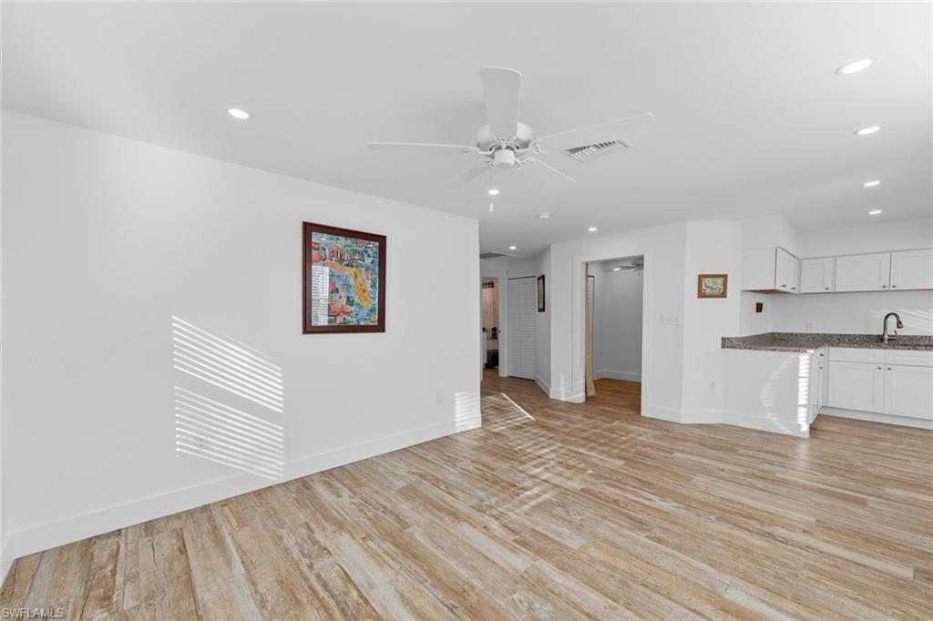 849 Beach Road Sanibel, FL 33957 - Photo 11 of 27 a view of a kitchen with wooden floor and a kitchen space