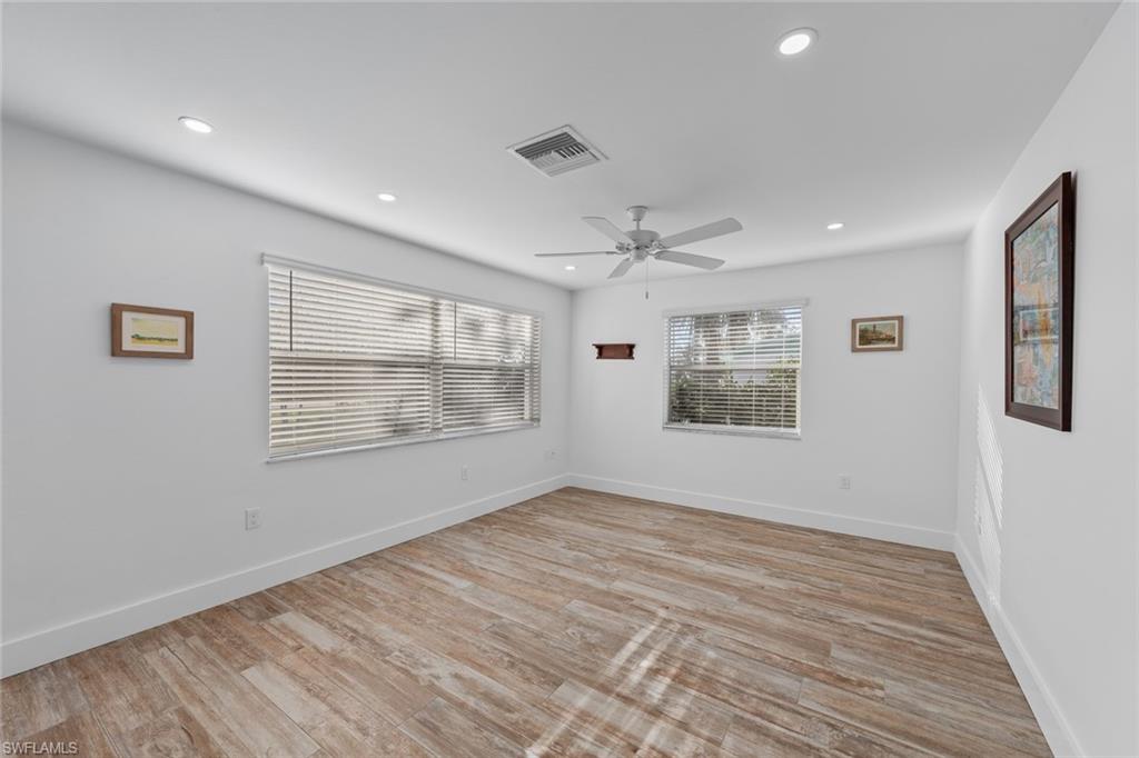 849 Beach Road Sanibel, FL 33957 - Photo 13 of 27 a view of an empty room with wooden floor and a window