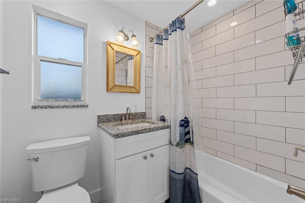 849 Beach Road Sanibel, FL 33957 - Photo 15 of 27 a bathroom with a granite countertop sink toilet and shower
