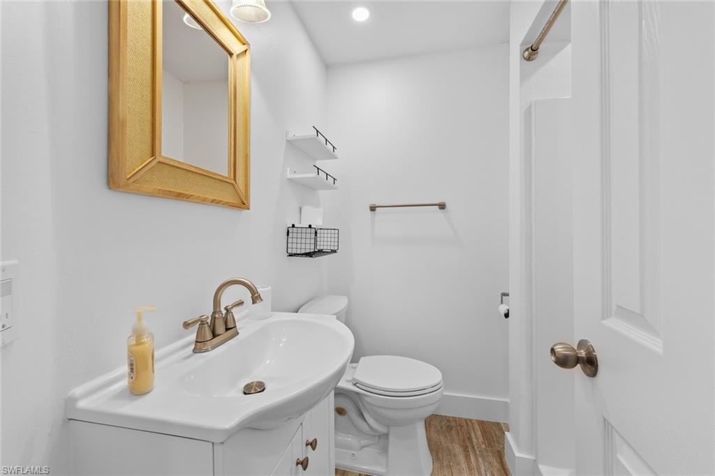 849 Beach Road Sanibel, FL 33957 - Photo 18 of 27 a bathroom with a sink mirror and toilet