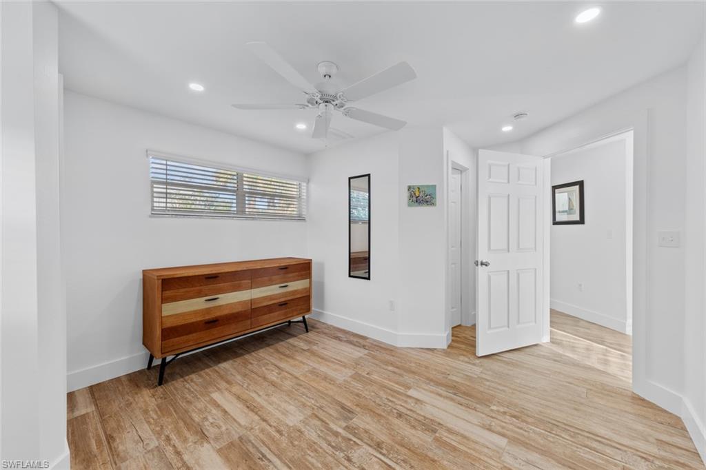 849 Beach Road Sanibel, FL 33957 - Photo 19 of 27 a view of an empty room with wooden floor and a window