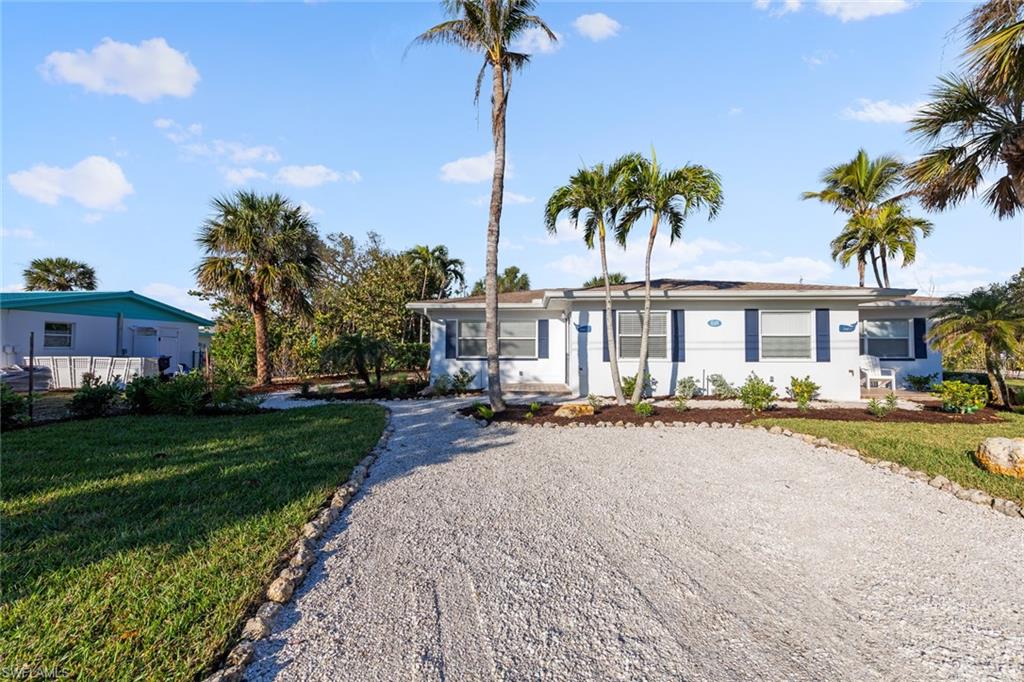 849 Beach Road Sanibel, FL 33957 - Photo 22 of 27 a front view of a house with yard and porch
