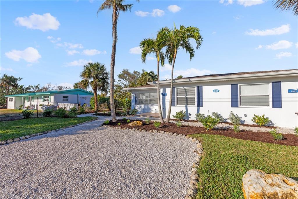 849 Beach Road Sanibel, FL 33957 - Photo 23 of 27 a front view of house with yard and green space