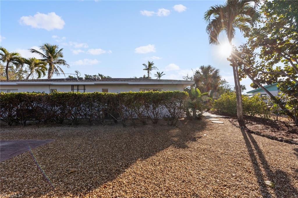 849 Beach Road Sanibel, FL 33957 - Photo 24 of 27 a view of a lake with a yard