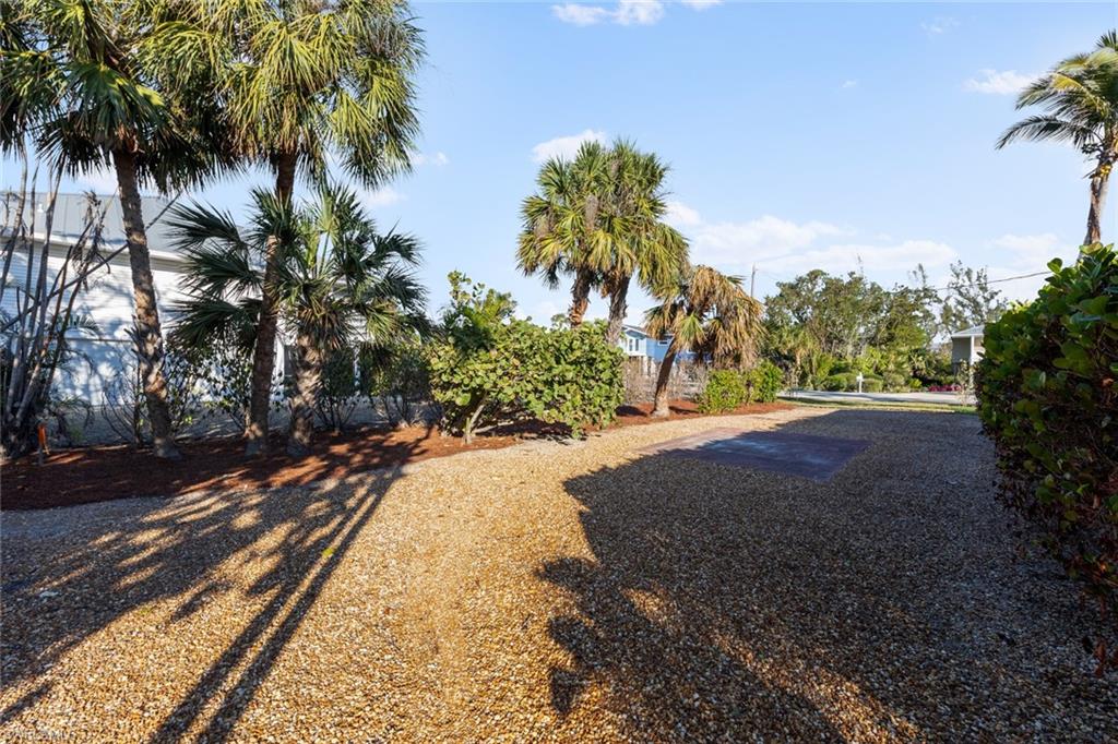 849 Beach Road Sanibel, FL 33957 - Photo 25 of 27 a view of a yard with plants and trees