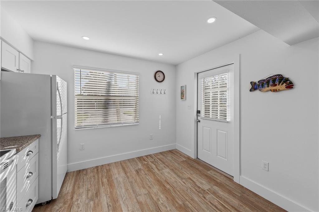 849 Beach Road Sanibel, FL 33957 - Photo 6 of 27 a view of an empty room with wooden floor and a window