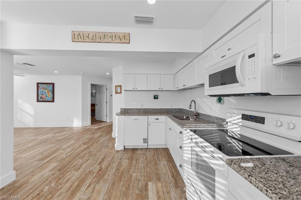 849 Beach Road Sanibel, FL 33957 - Photo 7 of 27 a kitchen with stainless steel appliances granite countertop a sink and a stove