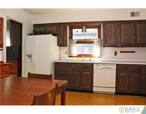 93 South Cliff Road Colonia, NJ 07067 - Photo 2 of 25 a kitchen with a sink cabinets and wooden floor