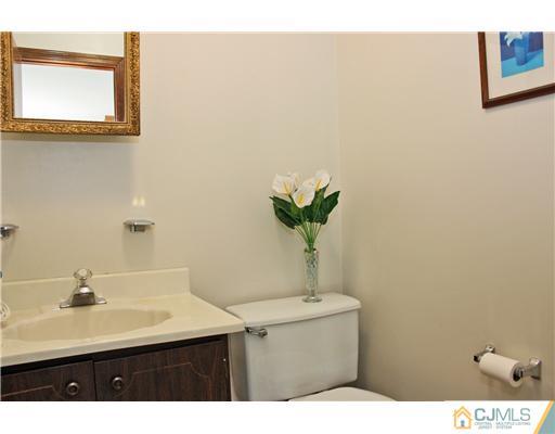 93 South Cliff Road Colonia, NJ 07067 - Photo 21 of 25 a bathroom with a sink and a mirror