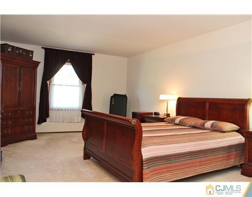 93 South Cliff Road Colonia, NJ 07067 - Photo 6 of 25 a bedroom with a bed and a window