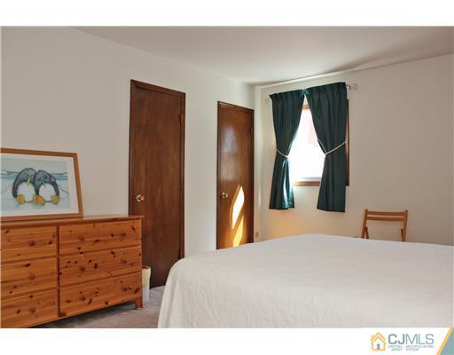 93 South Cliff Road Colonia, NJ 07067 - Photo 7 of 25 a bedroom with a bed and a dresser