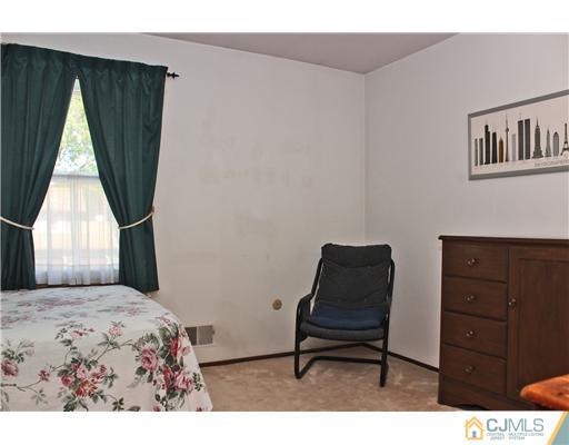 93 South Cliff Road Colonia, NJ 07067 - Photo 9 of 25 a bedroom with a bed and a window