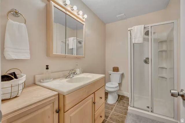 11789 Nicklaus Road Sandy, UT 84092 - Photo 36 of 58 Full bathroom with a stall shower, vanity, and light tile patterned floors