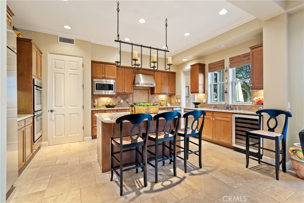 2438 Battering Rock Road Templeton, CA 93465 - Photo 33 of 60 a kitchen with stainless steel appliances kitchen island granite top and refrigerator