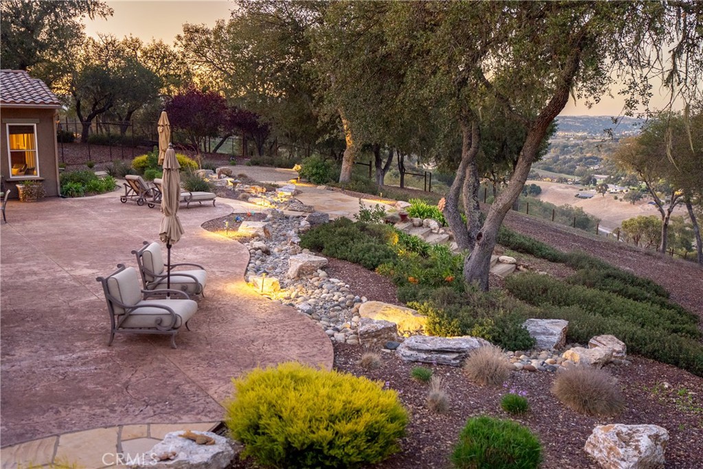 2438 Battering Rock Road Templeton, CA 93465 - Photo 46 of 60 a view of a backyard with table and chairs and a fire pit