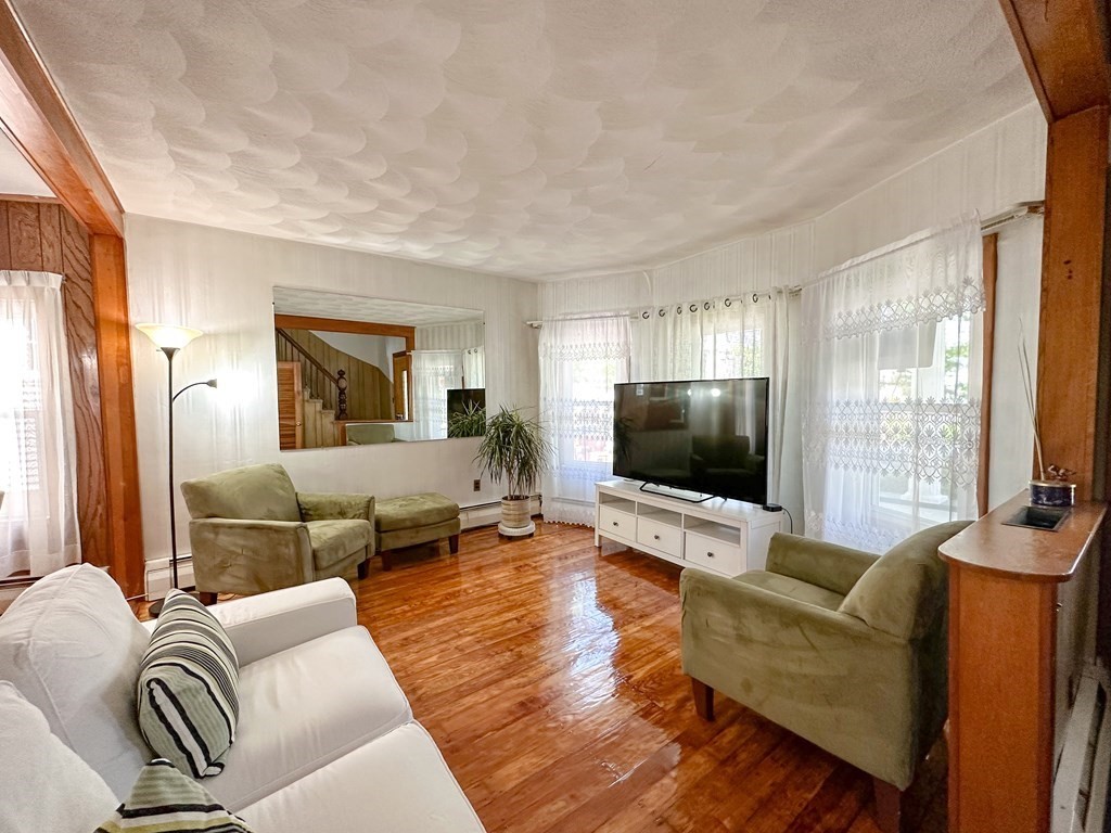 82 Jefferson Avenue Everett, MA 02149 - Photo 12 of 37 a living room with furniture and a flat screen tv