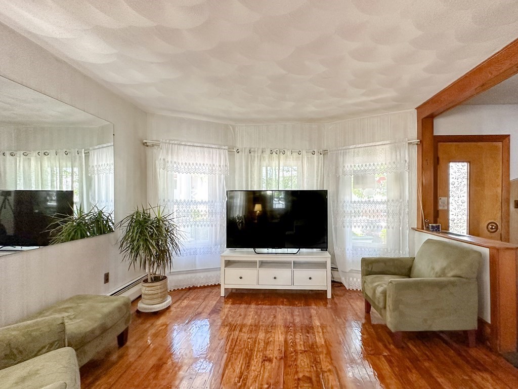 82 Jefferson Avenue Everett, MA 02149 - Photo 13 of 37 a living room with furniture and a flat screen tv