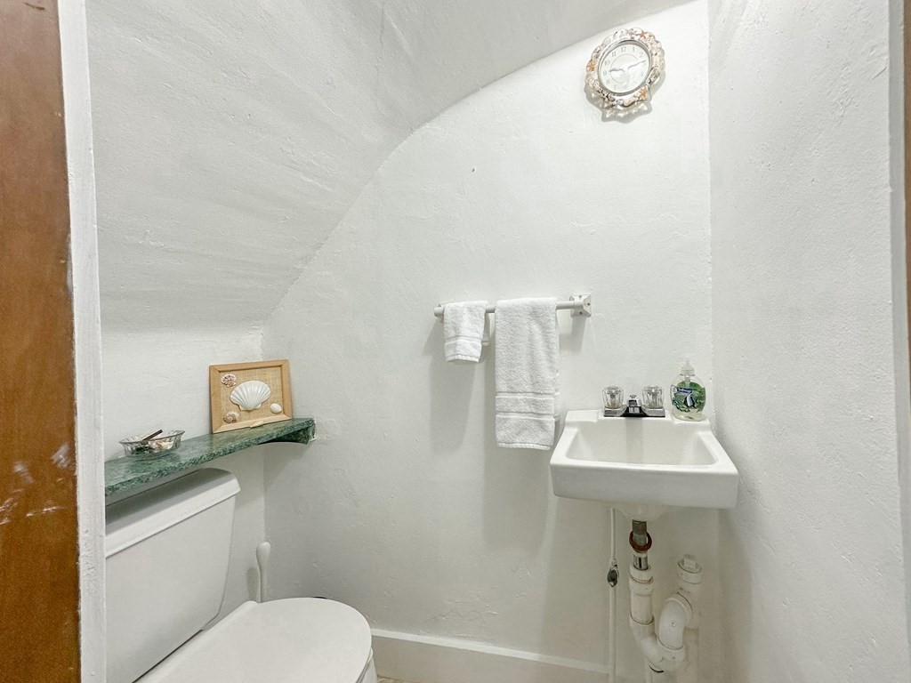 82 Jefferson Avenue Everett, MA 02149 - Photo 15 of 37 a bathroom with a toilet sink and mirror