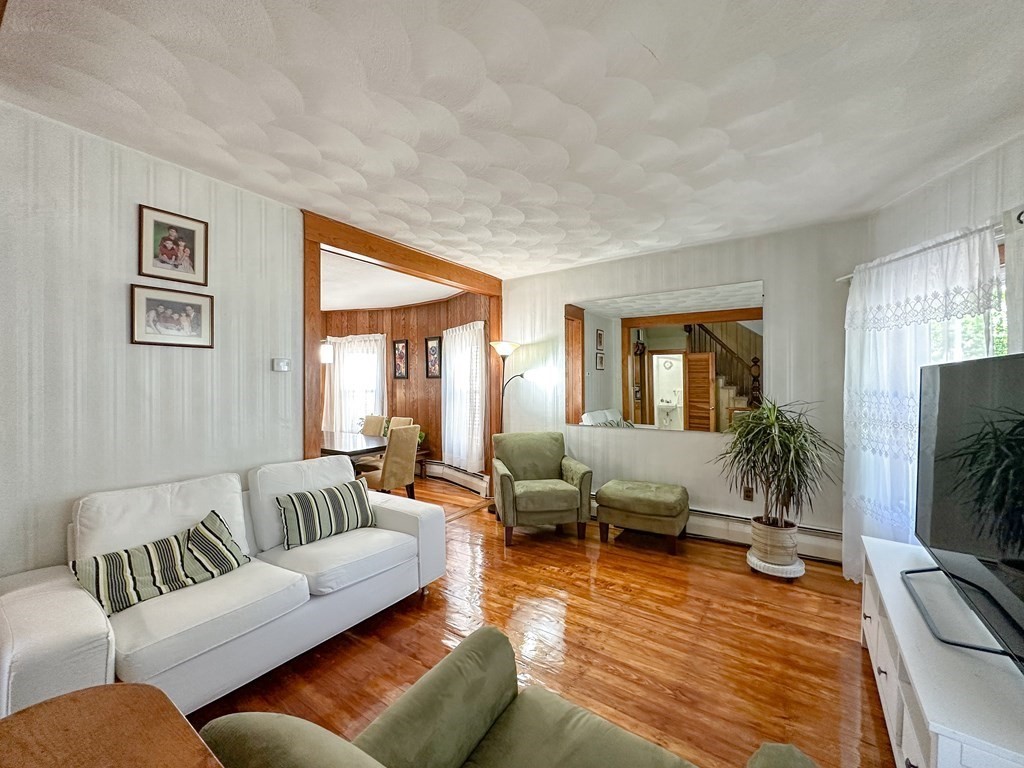82 Jefferson Avenue Everett, MA 02149 - Photo 16 of 37 a living room with furniture and a flat screen tv