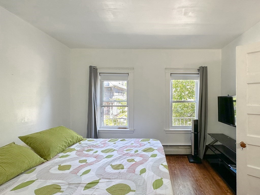 82 Jefferson Avenue Everett, MA 02149 - Photo 18 of 37 a bedroom with a bed tv and a window