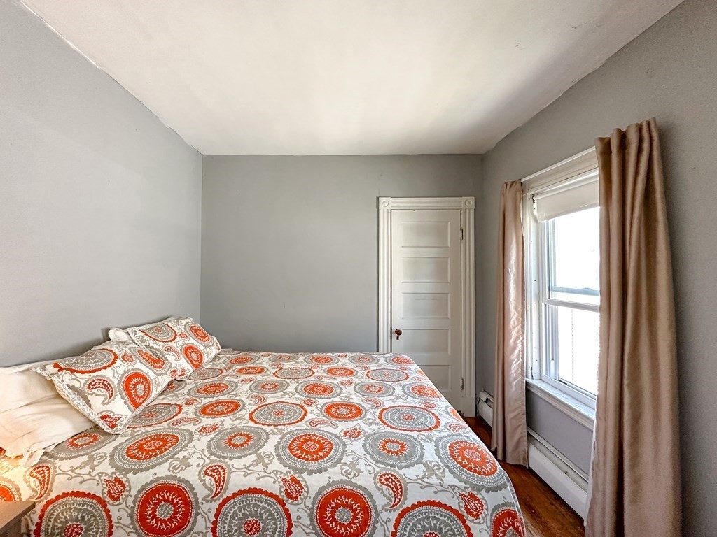 82 Jefferson Avenue Everett, MA 02149 - Photo 20 of 37 a bedroom with a bed and a window