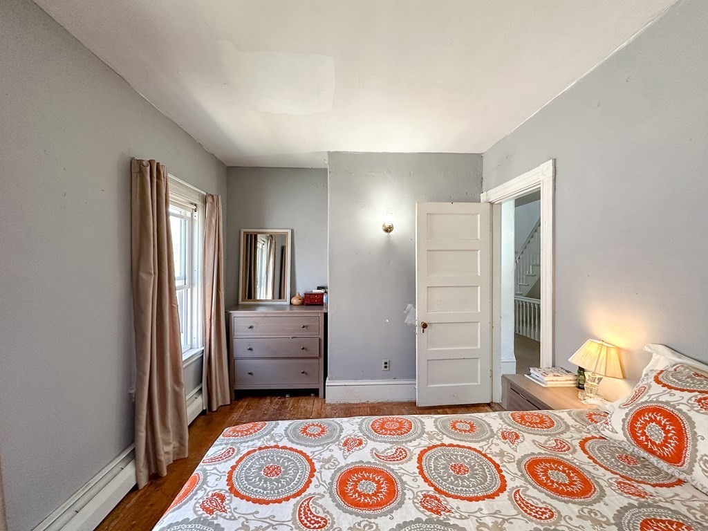 82 Jefferson Avenue Everett, MA 02149 - Photo 21 of 37 a bedroom with a bed and a dresser in it