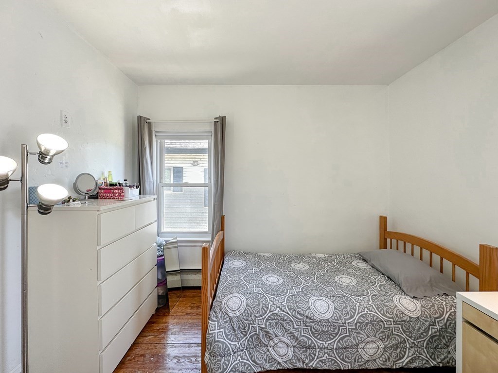 82 Jefferson Avenue Everett, MA 02149 - Photo 26 of 37 a bedroom with a bed and a window