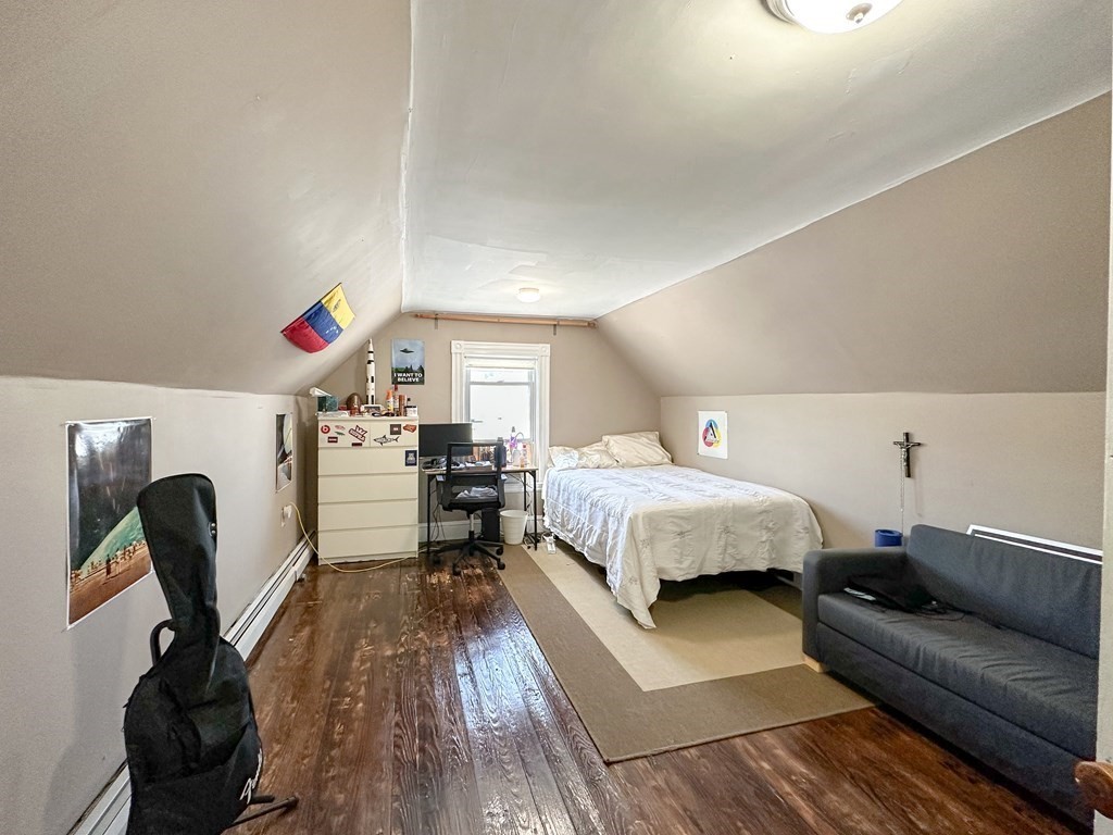 82 Jefferson Avenue Everett, MA 02149 - Photo 28 of 37 a bedroom with a bed and a chair