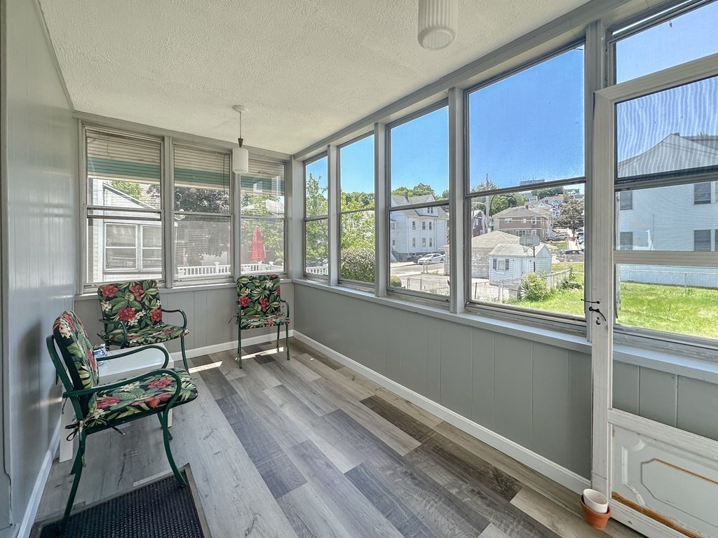 82 Jefferson Avenue Everett, MA 02149 - Photo 30 of 37 a living room with furniture and a floor to ceiling window