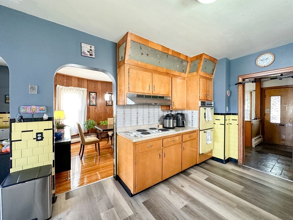82 Jefferson Avenue Everett, MA 02149 - Photo 3 of 37 a kitchen that has a lot of cabinets in it and wooden floors