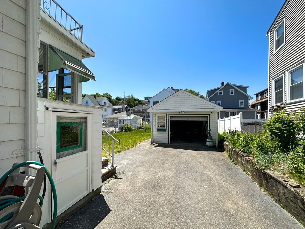 82 Jefferson Avenue Everett, MA 02149 - Photo 33 of 37 a view of a house with a garage and balcony