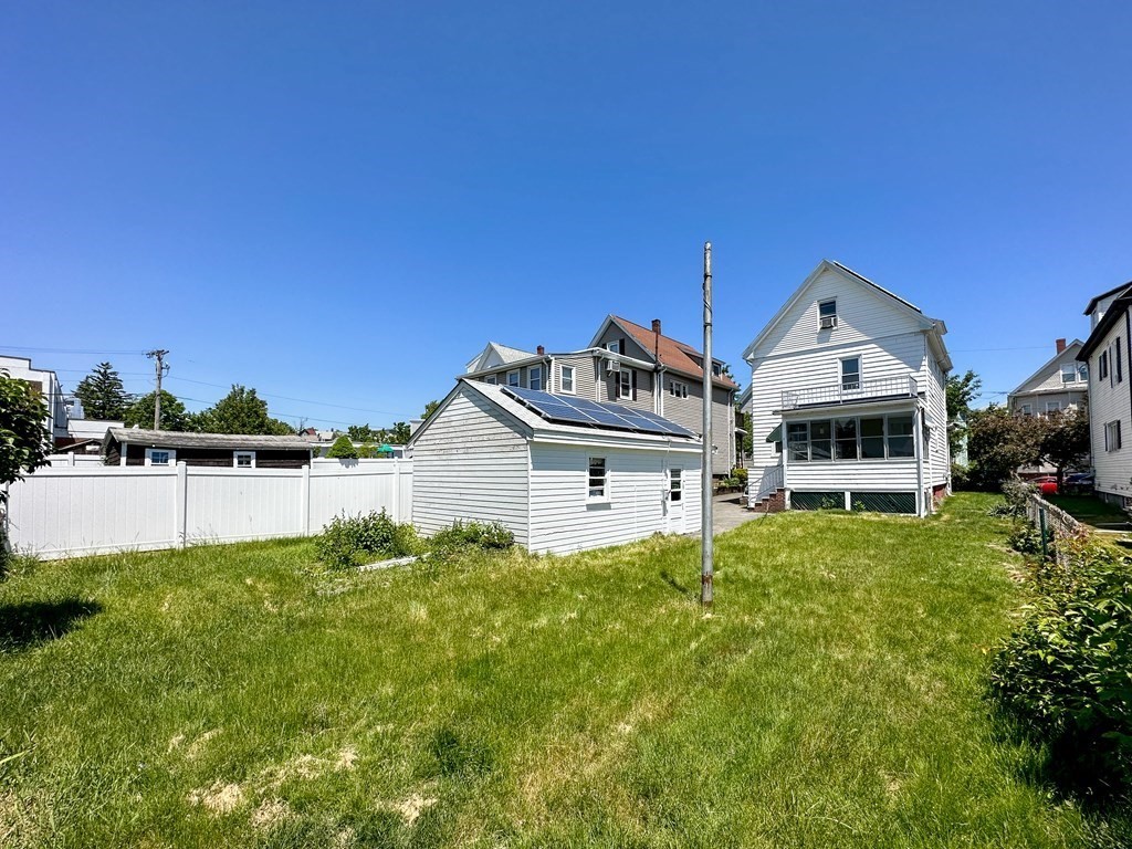 82 Jefferson Avenue Everett, MA 02149 - Photo 36 of 37 a front view of a house with a garden and plants